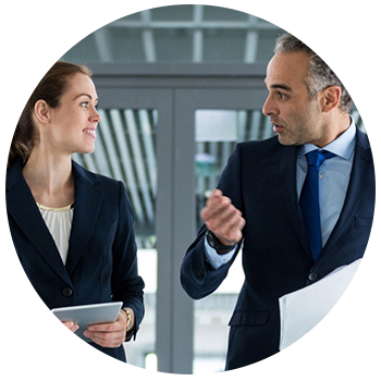 Two businesspeople talk while walking